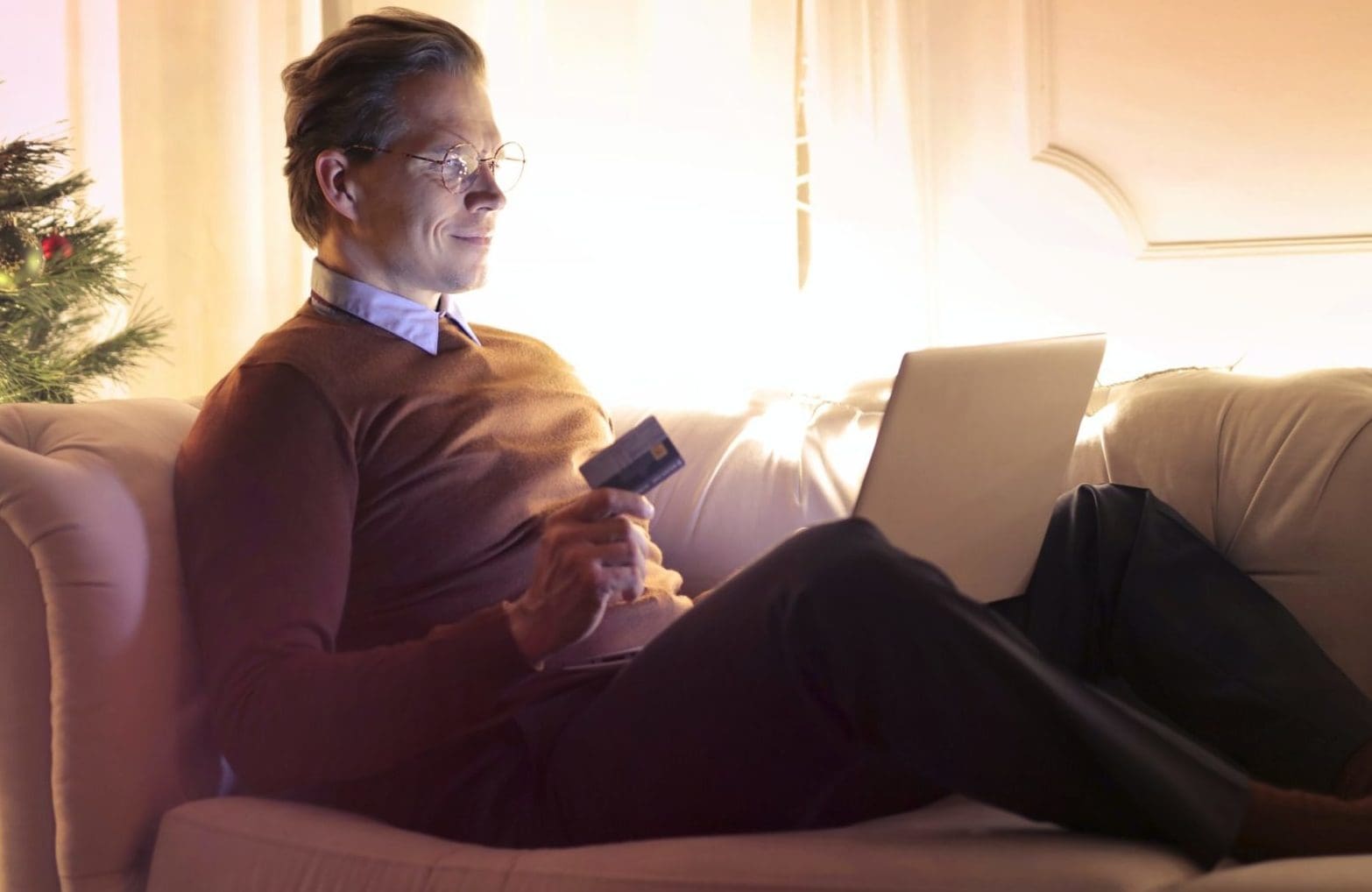 man sitting on couch purchasing on amazon