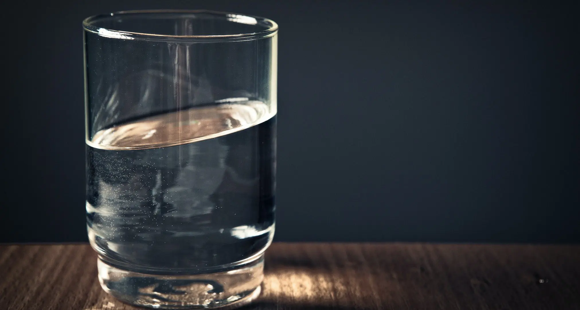 glass filled with clear drinking water