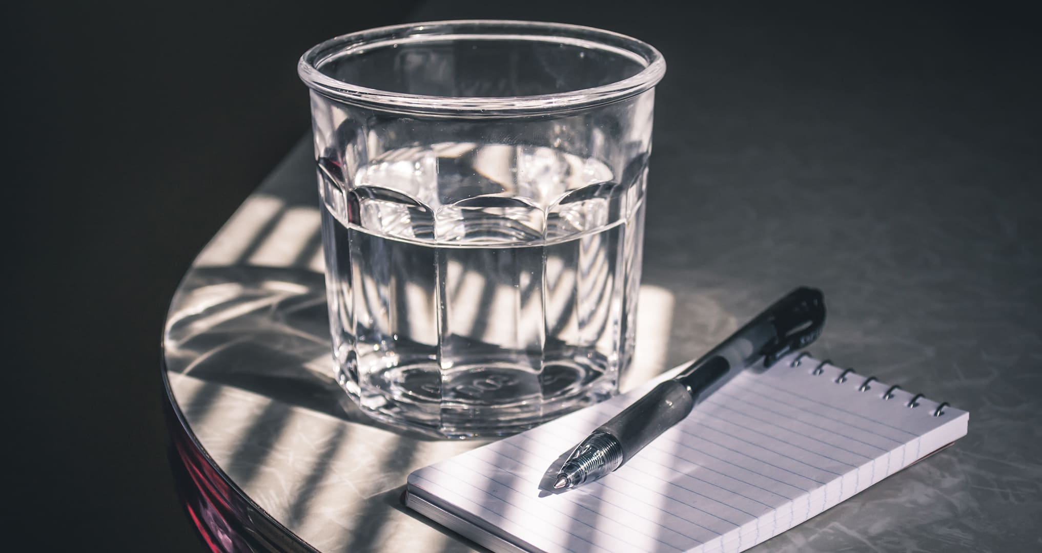 glass of water and notebook