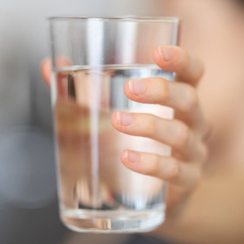 woman holding a glass of water