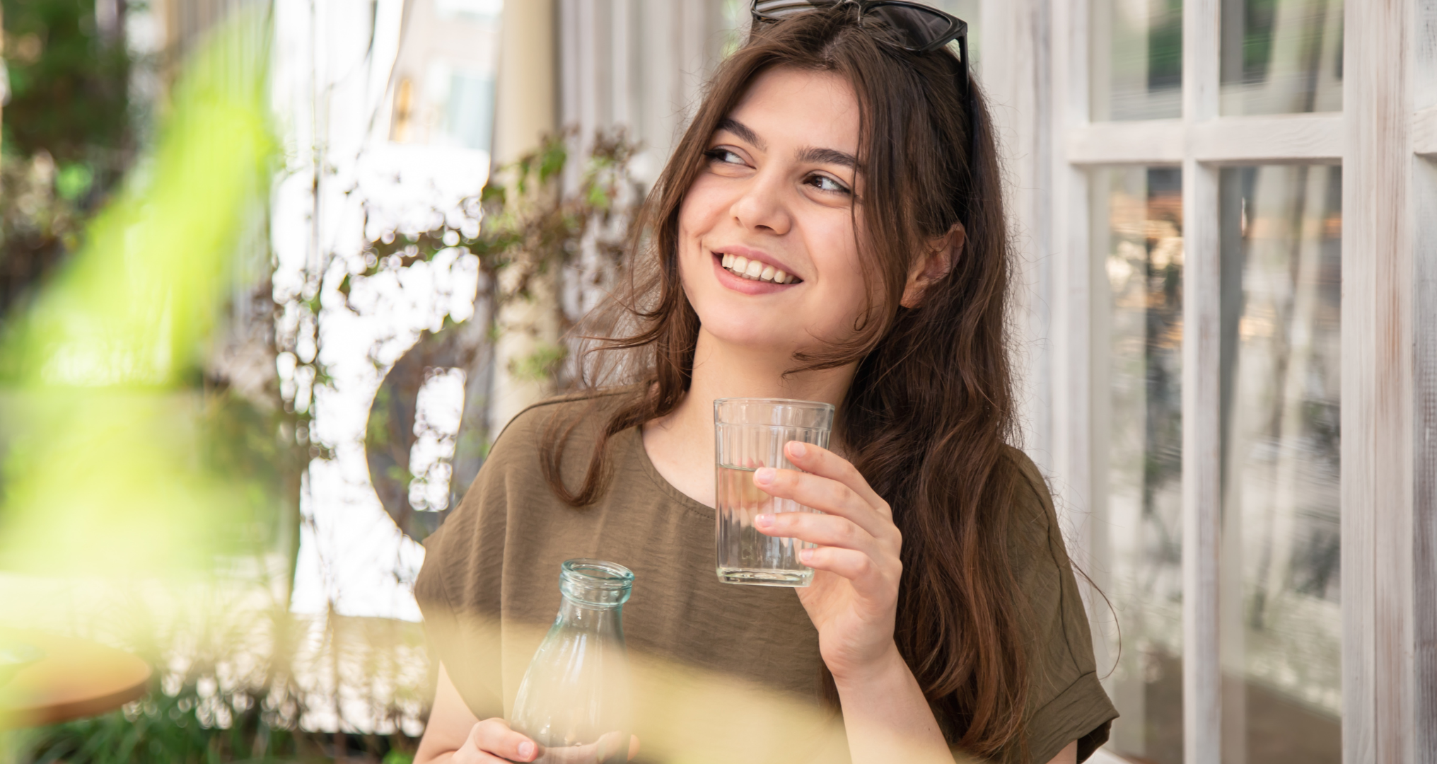 Attractive woman drinks water with lemon