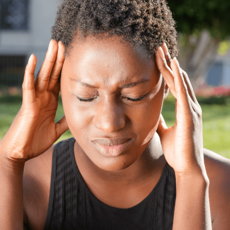 a woman feels signs of heat exhaustion in hot weather