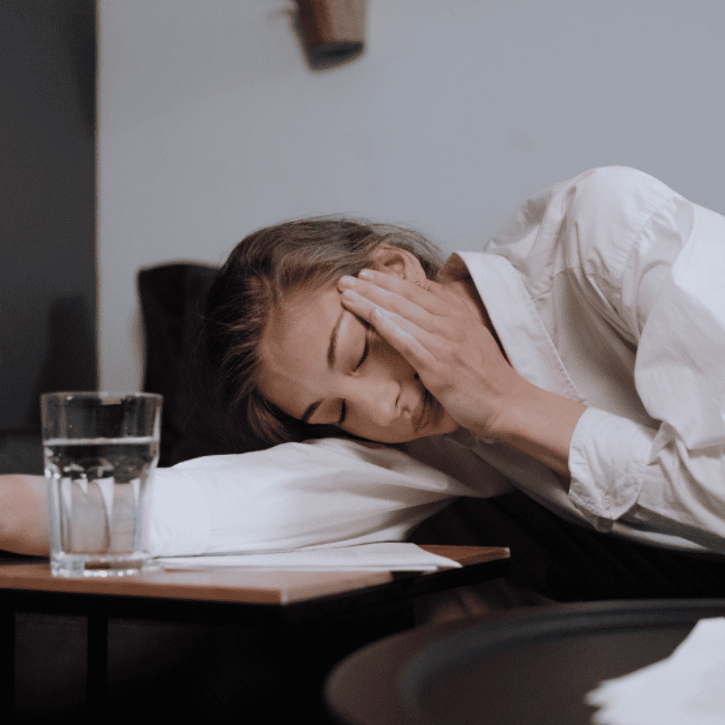 stressed woman with a glass of water