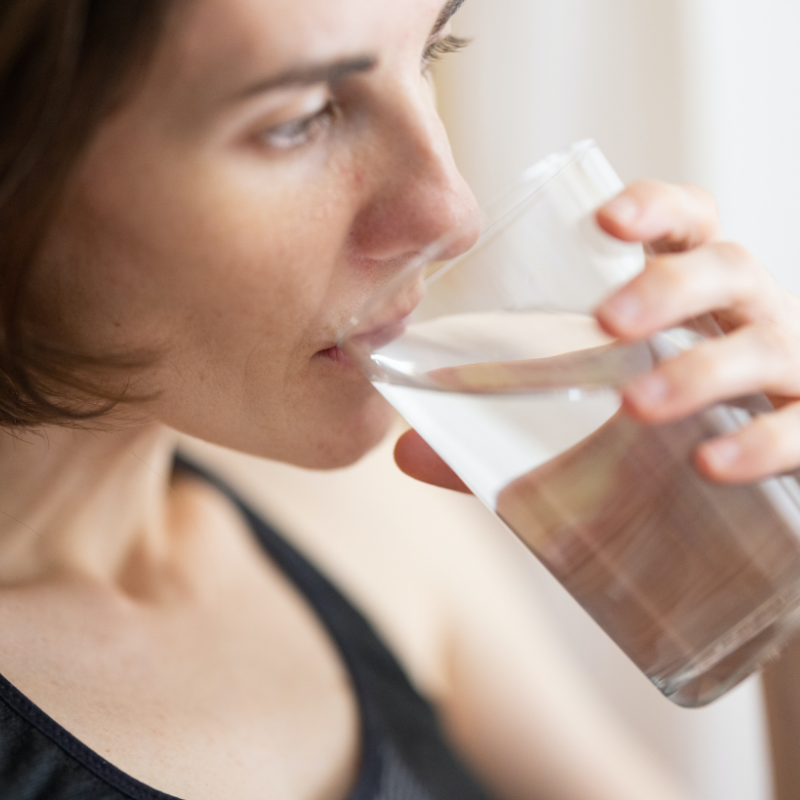 woman drinking a glass of water