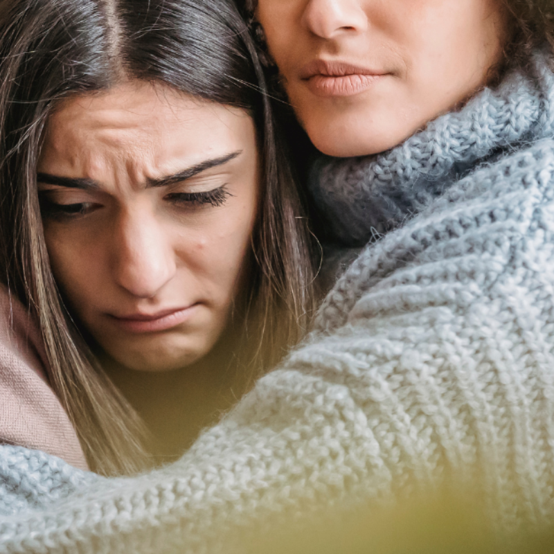 woman hugs friend with depressive disorders