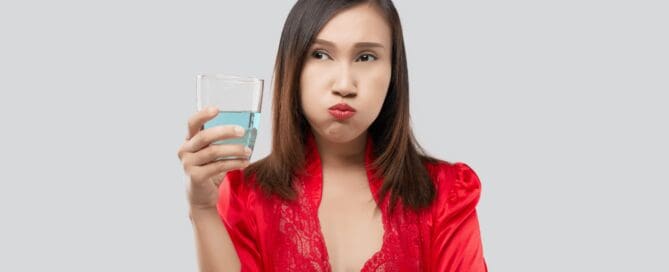 woman gargling fluoride treatment