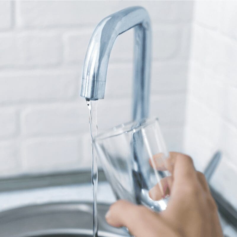 hand-holds-the-glass-filling-it-with-water-from-t (1) person filling up glass with tap water