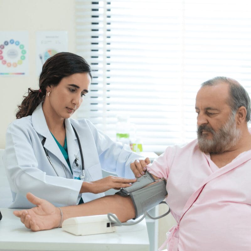 the-doctor-measures-the-patient-s-blood-pressure man seeing his doctor