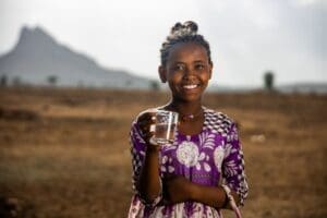 Ethiopian girl holding clean glass of water