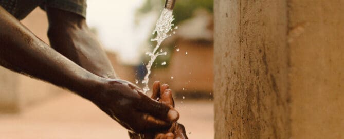 Man in Mali washing his hands with clean water