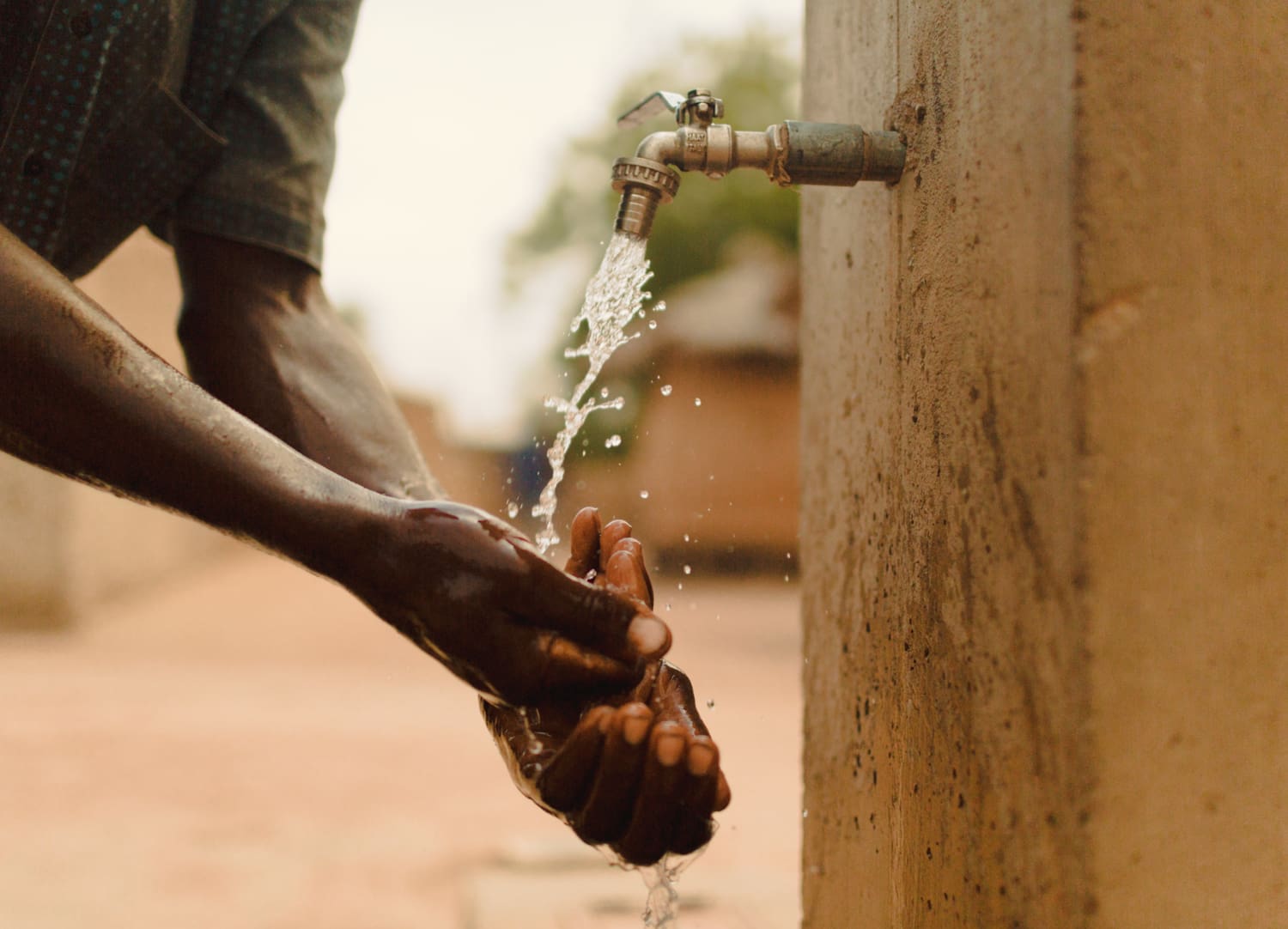 Man in Mali washing his hands with clean water