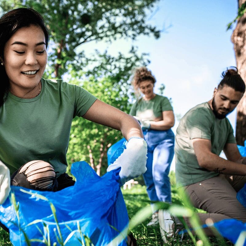 group of volunteers cleaning up a park