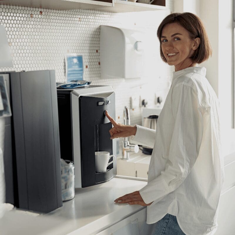 smiling business woman getting water