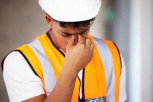 young worker suffering from heat stroke symptoms Young worker with headache related to heat stroke