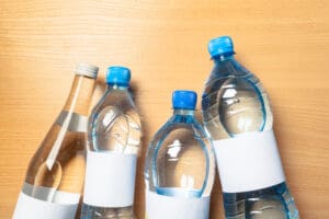 water bottle on the wooden table plastic water bottles on the wooden table