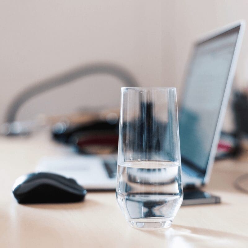 glass of water on desk at work