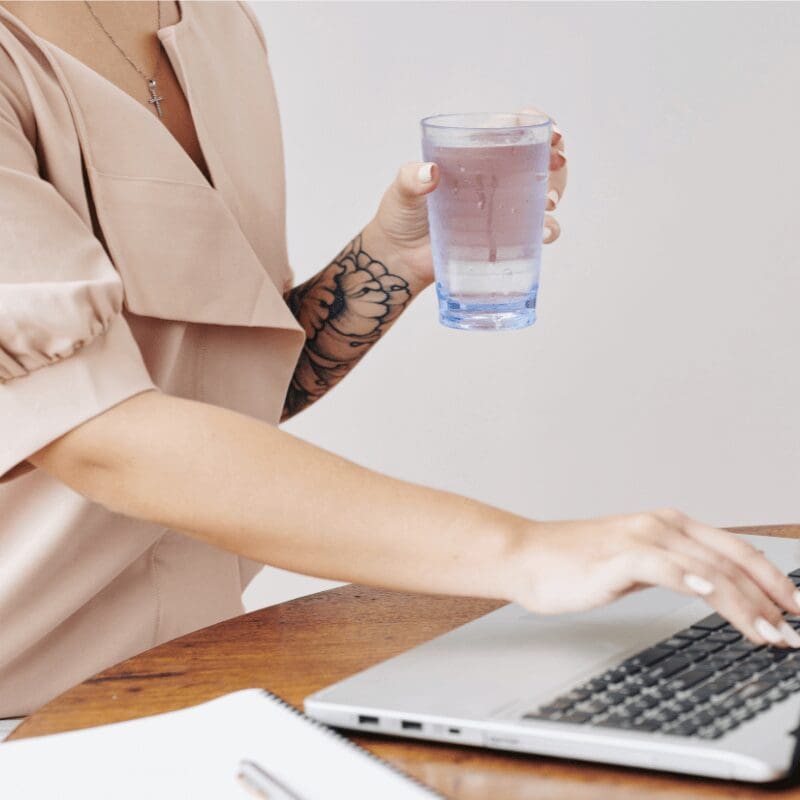 female working drinking water at work