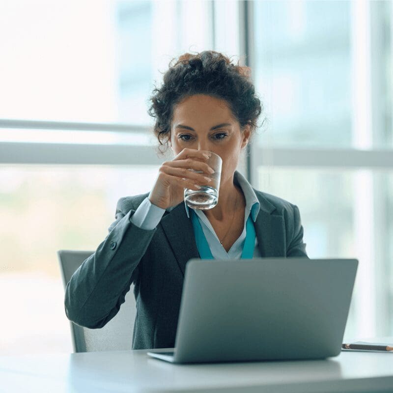 woman in the office drinking glass of water